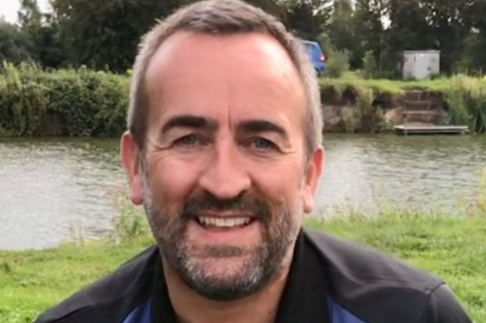 Head and shoulders image of Geoff Kettle, Customer Account Manager. The background features a river and grass banks.