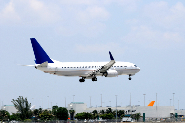 Bytron head to Miami for the annual Aircraft & Aerospace MRO & Flight Operations IT Conference 2018. Image of a white airplane with wheels down coming into land at an airport.