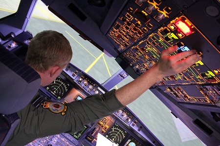 Aircraft pilot in aircraft cockpit checking instruments before takeoff