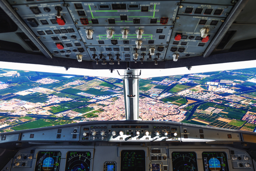 View of an airfield through the cockpit of an airpl